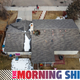 In this aerial view from a drone, people walk past a home with a hole in the roof from falling debris from an airplane engine on February 20, 2021 in Broomfield, Colorado. An engine on the Boeing 777 exploded after takeoff from Denver prompting the flight to return to Denver International Airport where it landed safely.